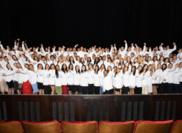 Students cheer at white coat ceremony