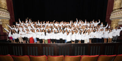 Students cheer at white coat ceremony