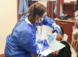 Student provides oral health screening at Back to School Brush-Up™