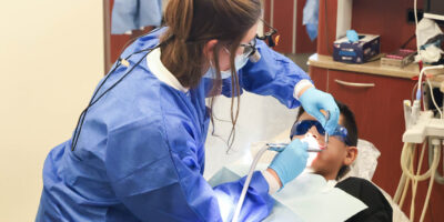 Student provides oral health screening at Back to School Brush-Up™