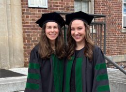 Dr. Kimberly Veltman poses with a friend after earning her medical degree.